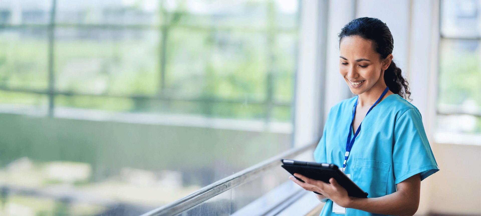 friendly nurse looking at a clipboard